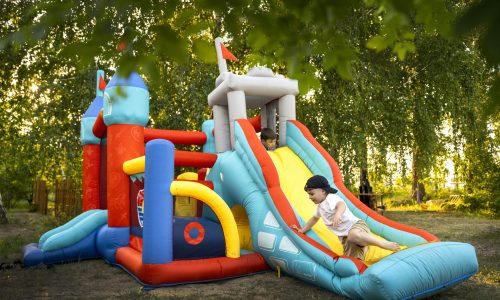 full-shot-kid-playing-in-bounce-house